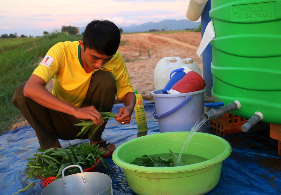 Chiến sỹ tổ công tác phòng chống dịch COVID-19 số 9 - Đồn Biên phòng Vĩnh Gia, Bộ đội Biên Phòng An Giang chuẩn bị bữa cơm chiều. (Ảnh: Công Mạo/TTXVN)