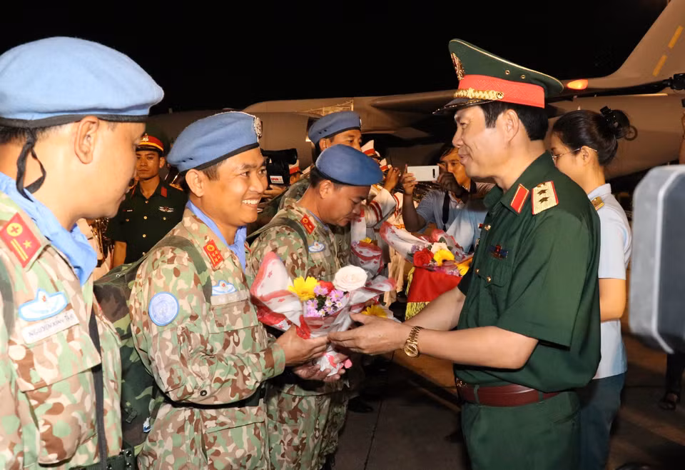 Trung tướng Nguyễn Tân Cương, Phó Tổng tham mưu trưởng Quân đội nhân dân Việt Nam tặng hoa chúc mừng các cán bộ, chiến sỹ Bệnh viện dã chiến cấp 2 số 1 trở về nước trong đợt này. (Ảnh: Xuân Khu/TTXVN)