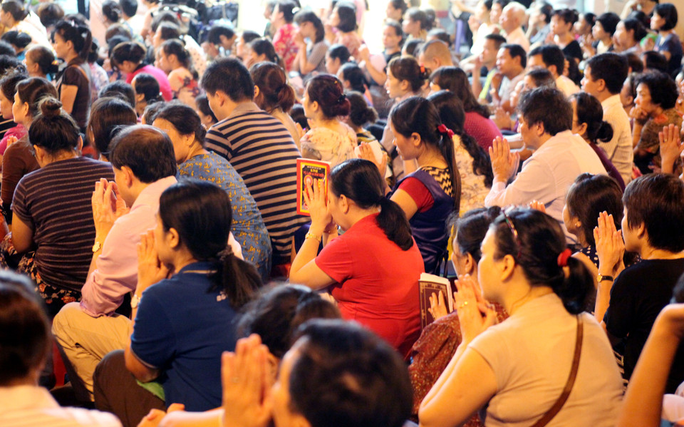 Người dân ngồi tràn xuống lòng đường dự lễ Vu Lan.(Doãn Đức/Vietnam+)