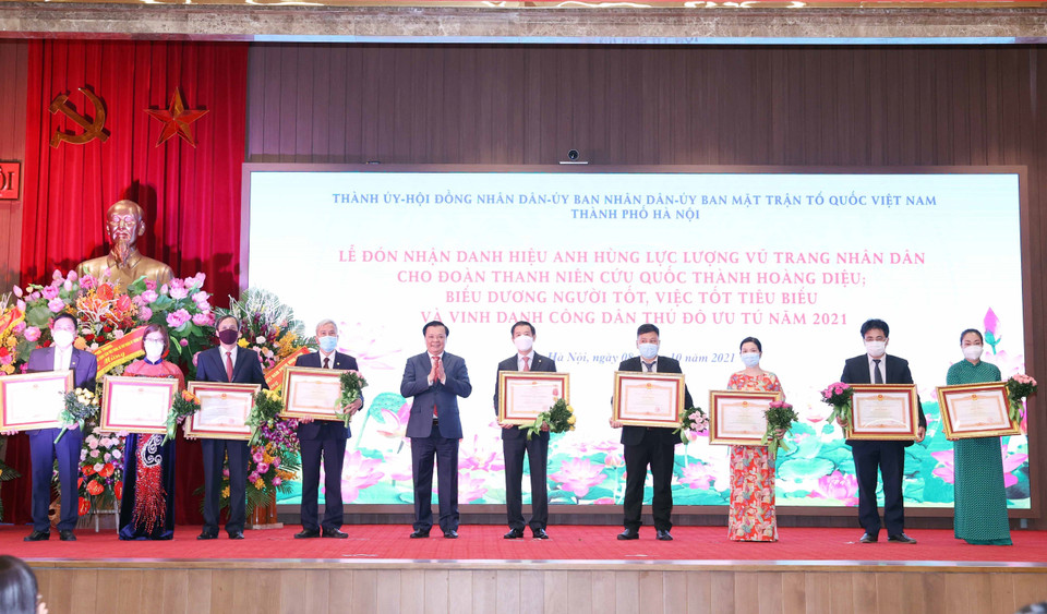 Đồng chí Đinh Tiến Dũng, Ủy viên Bộ Chính trị, Bí thư Thành ủy Hà Nội trao tặng Huân chương Lao động hạng Ba và Bằng khen của Thủ tướng Chính phủ cho tập thể và cá nhân có thành tích trong công tác phòng, chống dịch COVID- 19. (Ảnh: Thống Nhất/TTXVN)