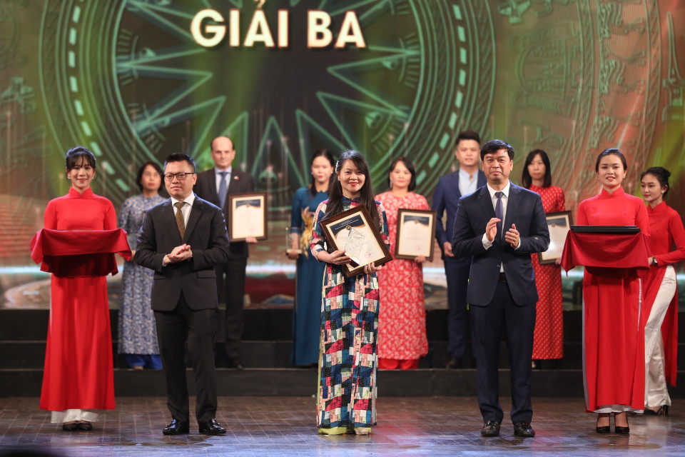 Ông Lê Quốc Minh, Tổng biên tập Báo Nhân dân và ông Ngô Minh Hiển, Phó Tổng giám đốc VOV trao giải Ba cho các tác giả, nhóm tác giả đoạt giải. (Ảnh: Minh Quyết/TTXVN)