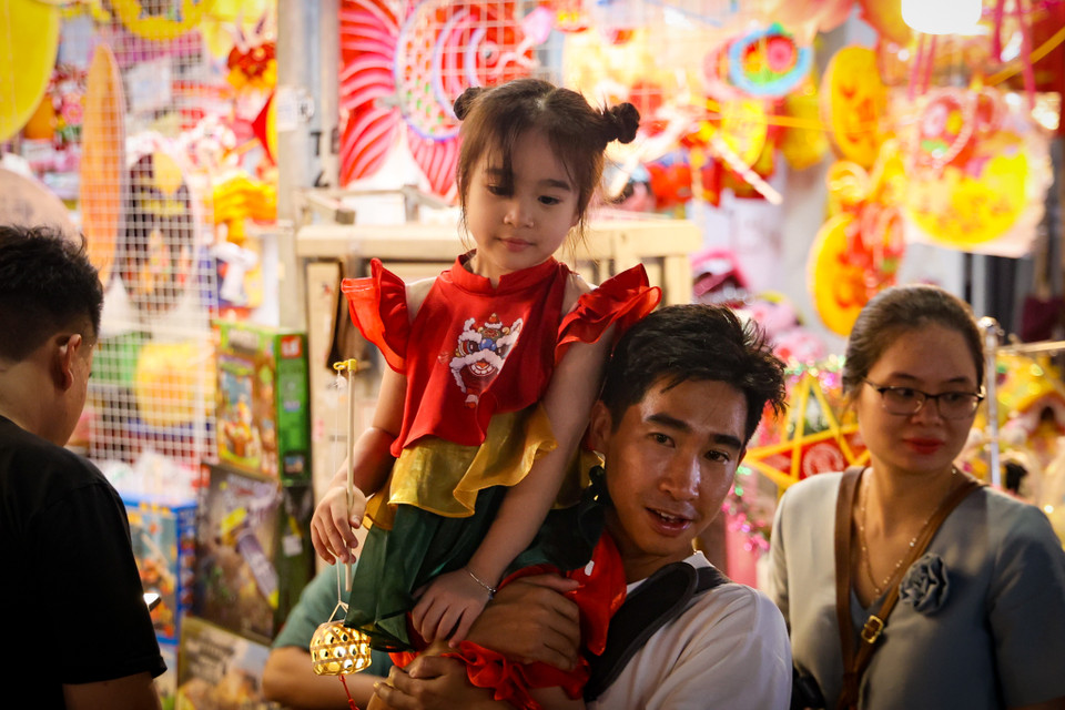 Dù là ngày trong tuần nhưng nhiều gia đình vẫn tranh thủ đưa các con đi chơi trong buổi tối. (Ảnh: Minh Hiếu/Vietnam+)