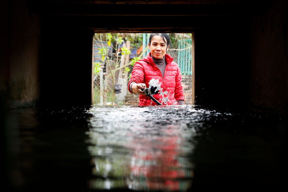 Niềm vui của chị Tính, thôn 6 khi được sử dụng nước sạch. (Ảnh: Minh Quyết/TTXVN)