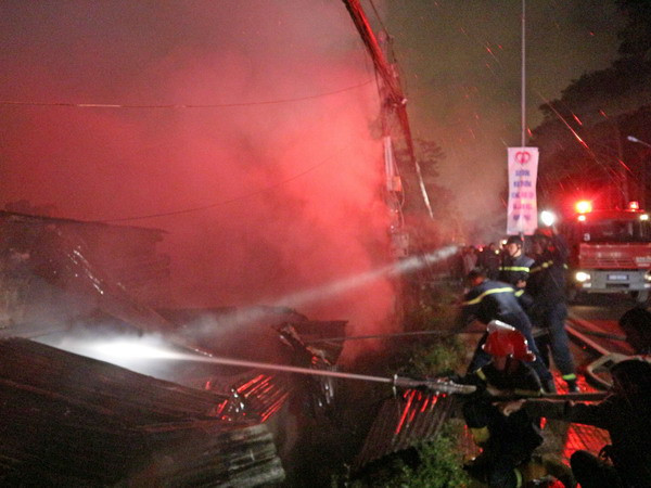 Lực lượng cảnh sát phòng cháy chữa cháy tiếp cận hiện trường vụ hoả hoạn. (Ảnh: Nguyễn Dũng/TTXVN)