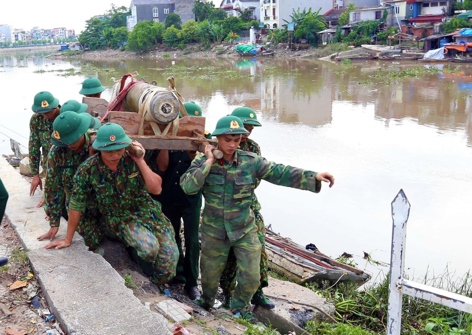 Các lực lượng chức năng di dời quả bom tại khu vực cầu mới sông Tam Bạc, khu vực phường Hạ Lý, quận Hồng Bàng tới nơi hủy nổ. (Ảnh: An Đăng/TTXVN)