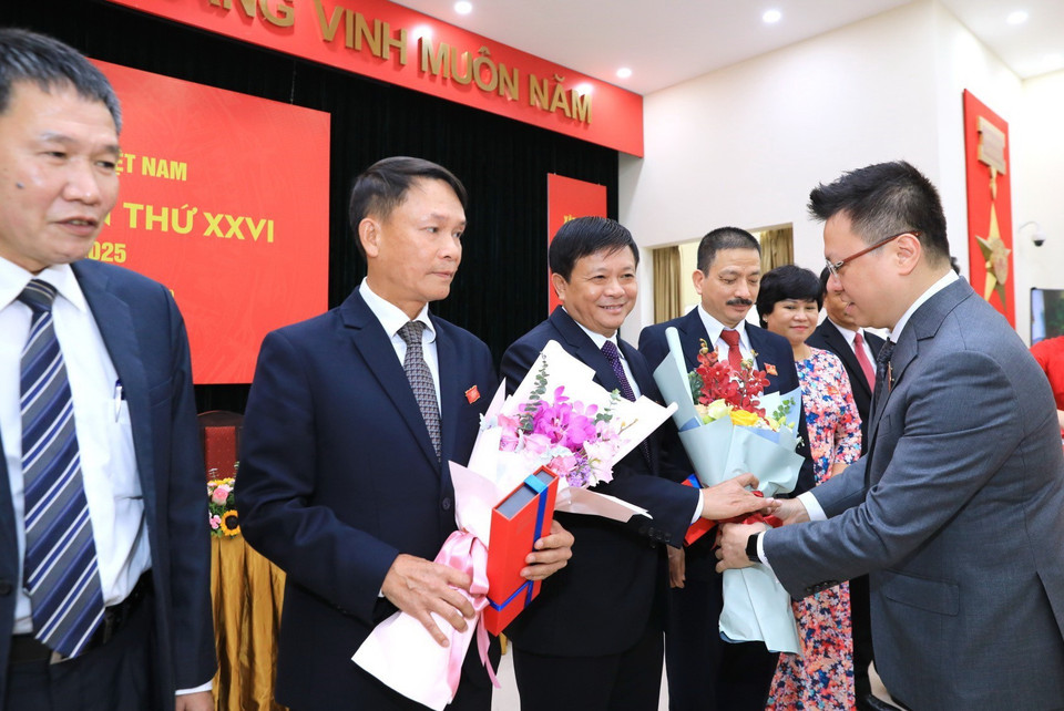 Đồng chí Lê Quốc Minh, Ủy viên Ban Thường vụ, Phó Tổng giám đốc TTXVN tặng hoa các đồng chí Ủy viên BCH Đảng bộ TTXVN khóa XXV không tiếp tục tham gia BCH khóa XXVI. (Ảnh: Thành Đạt/TTXVN)