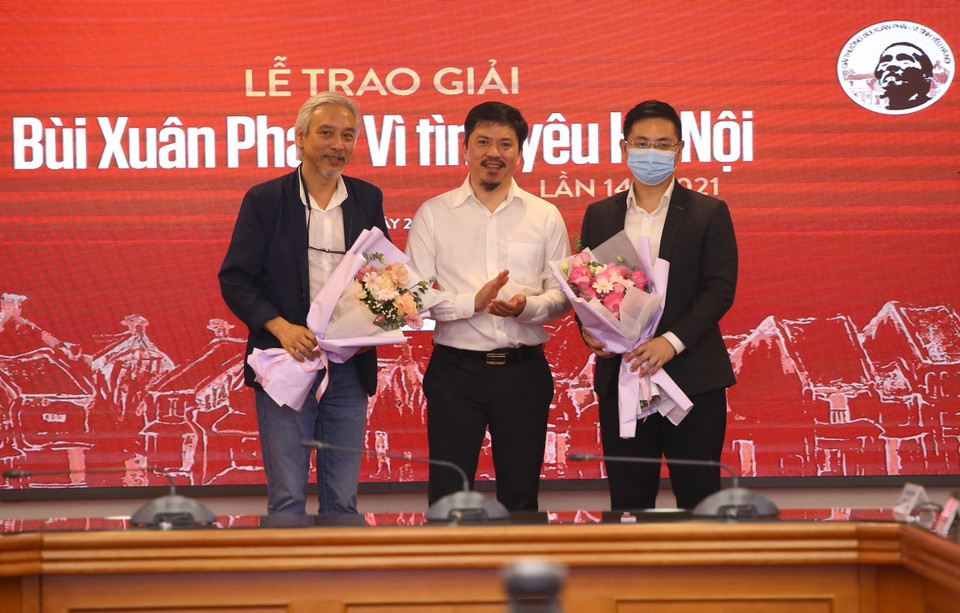 Tổng Biên tập Báo Thể thao và Văn hóa Lê Văn Thành tặng hoa cho đại diện nhà tài trợ và Ban giám khảo. (Ảnh: Hoàng Hiếu/TTXVN)