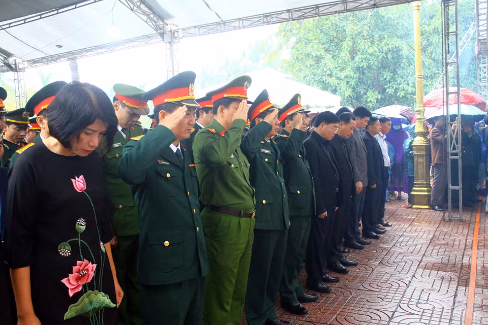Các đại biểu tưởng niệm, tiễn đưa các liệt sỹ về với đất mẹ. (Ảnh: Tá Chuyên/TTXVN)