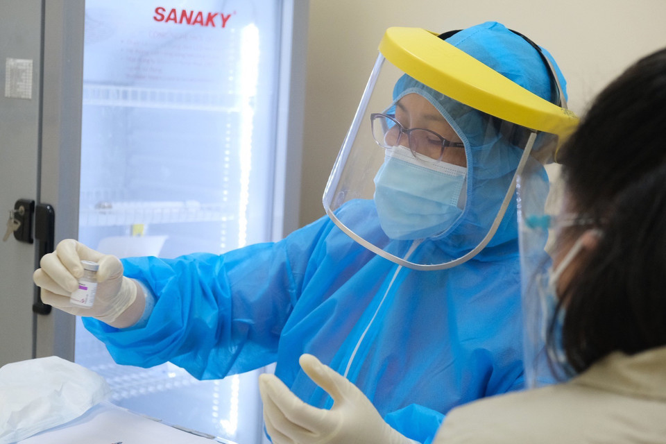 Bác sỹ Bệnh viện Hùng Vương Thành phố Hồ Chí Minh hướng dẫn quy trình tiêm vaccine phòng COVID-19 cho thai phụ. (Ảnh: TTXVN phát)