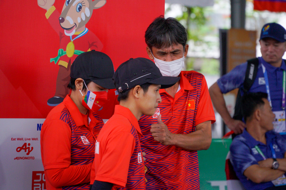 Huấn luyện viên Ngô Văn Thìn đang hội ý chiến thuật với các vận động viên. (Ảnh: Minh Hiếu/Vietnam+)