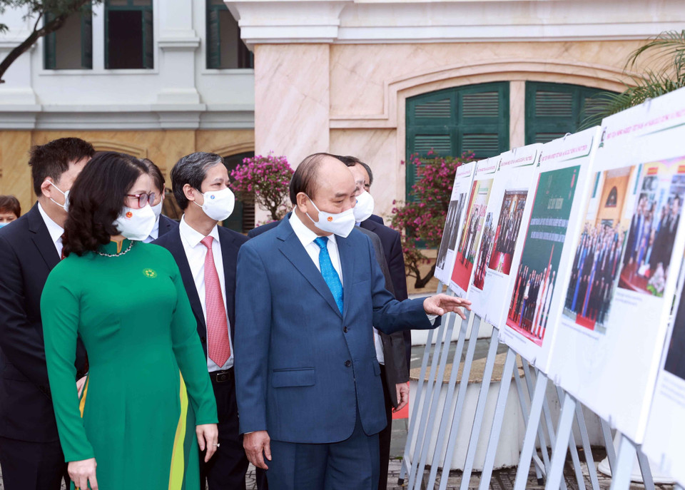 Chủ tịch nước Nguyễn Xuân Phúc xem trưng bày ảnh do Thông tấn xã Việt Nam và Học viện Nông nghiệp Việt Nam phối hợp tổ chức. (Ảnh: Thống Nhất/TTXVN)