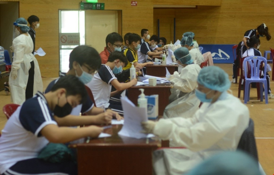 Học sinh làm thủ tục tiêm vaccine tại Cung thể Thao Tiên Sơn. (Ảnh: Văn Dũng/TTXVN)