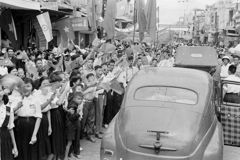 Nhân dân chào đón đoàn xe Ủy ban quân chính qua phố Hàng Ngang. (Ảnh: TTXVN)