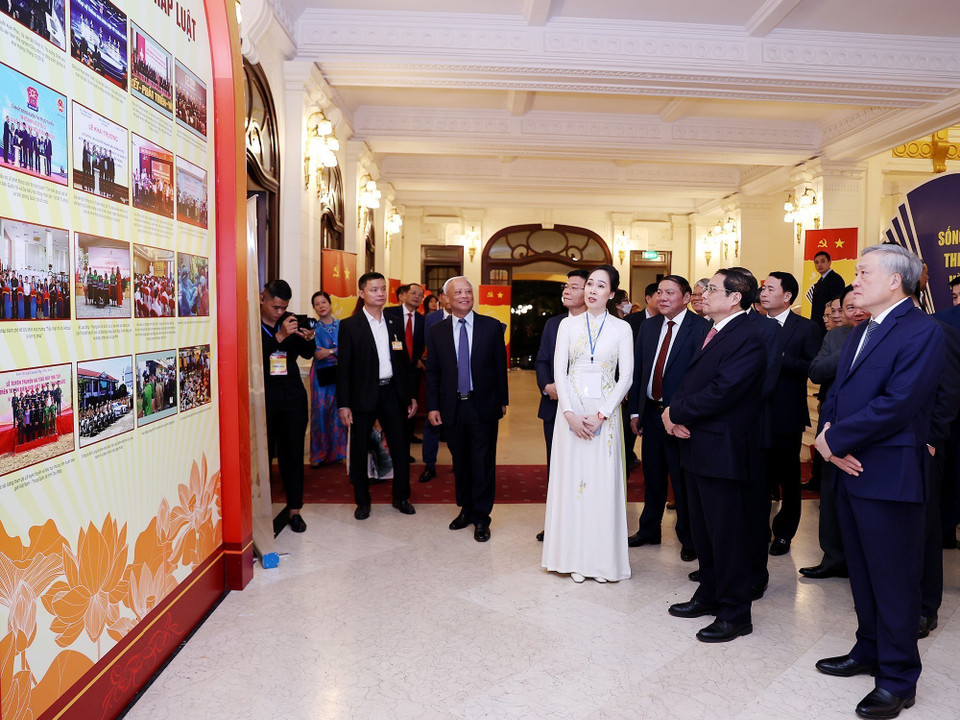 Thủ tướng Phạm Minh Chính tham quan trưng bày hình ảnh về các hoạt động hưởng ứng Pháp luật Việt Nam năm 2022. (Ảnh: Dương Giang/TTXVN)