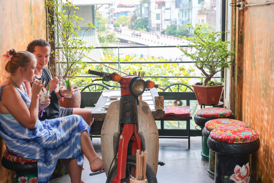 Xe máy, lốp xe cũ hỏng … biến thành bàn, ghế phục vụ du khách đến quán càphê trên phố Hàng Mắm. (Ảnh: Hoàng Hiếu/TTXVN)