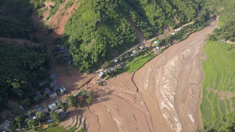 Trận mưa lũ lịch sử kéo theo bùn đất từ đầu nguồn đổ về bản Poọng, làm sập và hư hỏng nhiều căn nhà, vùi lấp nhiều hoa màu của người dân. (Ảnh: Quyết Đạt/TTXVN)