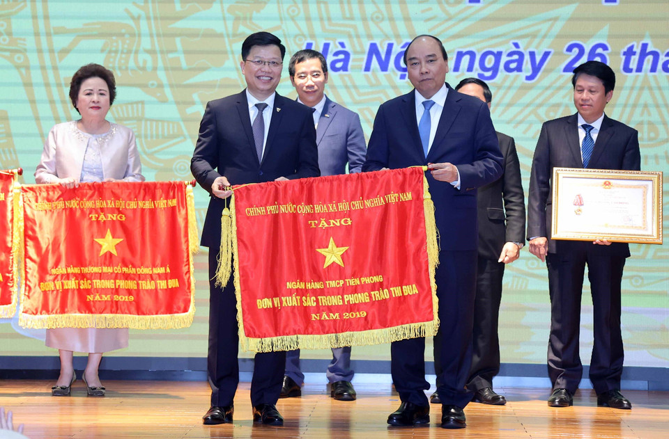 Thủ tướng Nguyễn Xuân Phúc tặng Cờ Thi đua Chính phủ cho Ngân hàng Thương mại cổ phần Tiên Phong. (Ảnh: Thống Nhất/TTXVN)