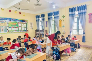 Học sinh dân tộc Chứt luôn nhận được sự quan tâm, dạy bảo ân cần của giáo viên. (Ảnh: Hữu Quyết/TTXVN)