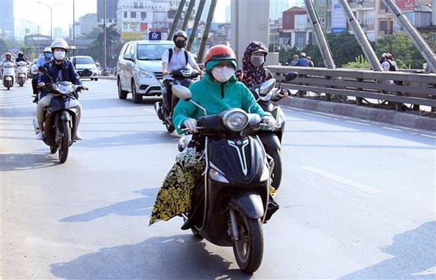 Người dân trang bị cho mình những trang phục bịt kín để chống chọi với nắng nóng gay gắt. (Ảnh: Quang Quyết/TTXVN) Miền Bắc nắng nóng cục bộ, Nam Bộ tiếp tục có mưa và dông ảnh 1