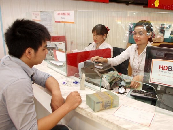 Ảnh minh họa. (Nguồn: CTV/Vietnam+) Cho phép ngân hàng cơ cấu nợ đối với khách hàng bị ảnh hưởng COVID-19 ảnh 1