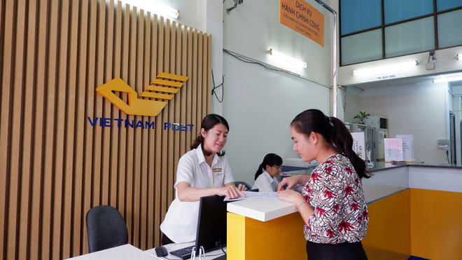 Vietcombank và VNPOST triển khai dịch vụ ngân hàng tại 6.000 điểm ảnh 1