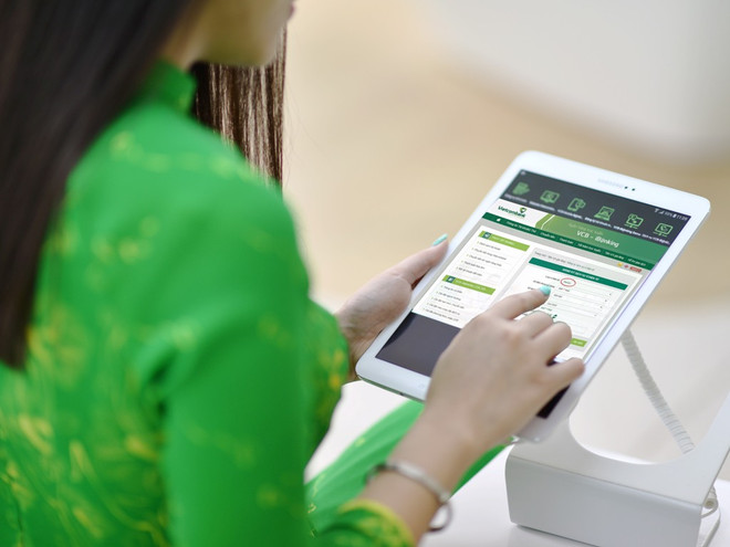 Ảnh minh họa. (Ảnh: CTV/Vietnam+) Vietcombank giảm phí dịch vụ chuyển tiền nhanh liên ngân hàng 24/7 ảnh 1