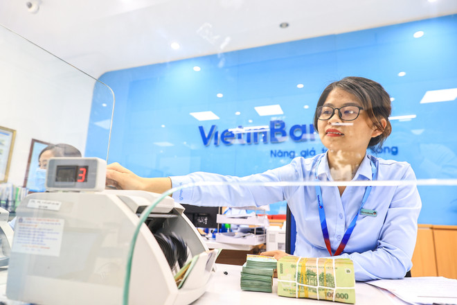 Ngân hàng giãn nợ một năm cho khách vay gặp khó khăn. (Ảnh: Vietnam+) NHNN: Khách vay gặp khó khăn được ngân hàng giãn nợ 12 tháng ảnh 1