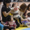 Các em bé tham gia cuộc thi bò dành cho trẻ sơ sinh tại Yokohama,ngoại ô Tokyo, Nhật Bản. (Ảnh: AFP/TTXVN)