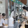 Người dân đến khám bệnh đăng ký tại quầy tiếp đón. (Ảnh: Minh Quyết/TTXVN)