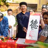 Du khách được tặng chữ thư pháp đầu năm mới Bính Ngọ ở Thế Miếu, Đại Nội Huế. (Ảnh: Nguyên Lý/TTXVN)