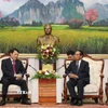 Ủy viên Bộ Chính trị, Thường trực Ban Bí thư, Phó Chủ tịch nước Lào Bounthong Chitmani (phải) tiếp Bộ trưởng Công an Lương Tam Quang. (Ảnh: Xuân Tú/TTXVN)