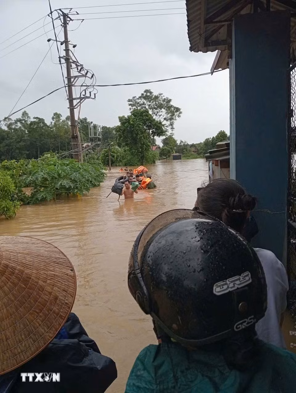 Lực lượng chức năng hỗ trợ nhân dân thôn Chẽ, xã Yên Thế sơ tán tài sản, vật nuôi, phòng tránh mưa bão. (Ảnh: TTXVN phát)