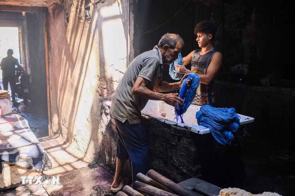 Một người thợ nhuộm các cuộn sợi tại xưởng nhuộm Salama ở Cairo, Ai Cập, ngày 16/9/2026. (Ảnh: THX/TTXVN phát)