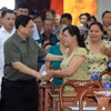 Thủ tướng Phạm Minh Chính với đối tượng chính sách, người có hoàn cảnh khó khăn tham dự chương trình. (Ảnh: Văn Điệp/TTXVN)