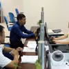 Người dân đến làm thủ tục hành chính tại khu vực của Sở Tài Nguyên và Môi trường ở Trung tâm hành chính công tỉnh Lai Châu.( Ảnh: Quý Trung/TTXVN)