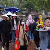 Mặc dù trời mưa nhẹ nhưng chiều tối ngày 14 tháng Giêng đông đảo du khách đến đền Trần để tham quan, vãn cảnh. (Ảnh: Công Luật/TTXVN)