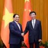 Thủ tướng Phạm Minh Chính hội kiến Chủ tịch Chính hiệp toàn quốc Trung Quốc Vương Hộ Ninh. (Ảnh: Dương Giang/TTXVN)
