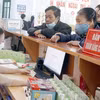 Người dân làm thủ tục khám chữa bệnh bảo hiểm y tế. (Ảnh: PV/Vietnam+)