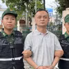 Đối tượng Lưu Trí Quân bị bắt giữ tại khu vực cửa khẩu. (Ảnh: TTXVN phát)