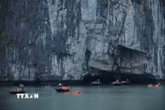 Du khách tham quan hang Luồn trên Vịnh Hạ Long. (Ảnh: Hoàng Hiếu/TTXVN)