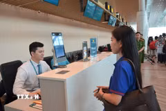 Hành khách thực hiện sinh trắc học nhận diện khuôn mặt trong quá trình làm thủ tục. (Ảnh: Linh Sơn/TTXVN)