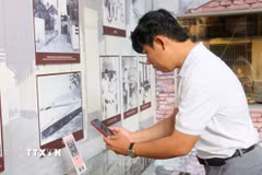Du khách quét QR để tìm hiểu thông tin tại Nhà trưng bày thân thế, sự nghiệp Chủ tịch Tôn Đức Thắng, nằm trong Khu lưu niệm Chủ tịch Tôn Đức Thắng, thuộc xã Mỹ Hòa Hưng, tỉnh An Giang. (Ảnh: Công Mạo/TTXVN)