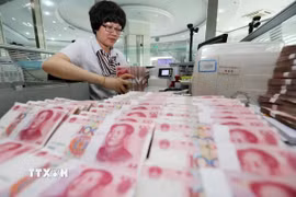 Nhân viên ngân hàng kiểm đếm đồng Nhân dân tệ tại thành phố Liên Vân Cảng, tỉnh Giang Tô, Trung Quốc. (Ảnh: THX/TTXVN)
