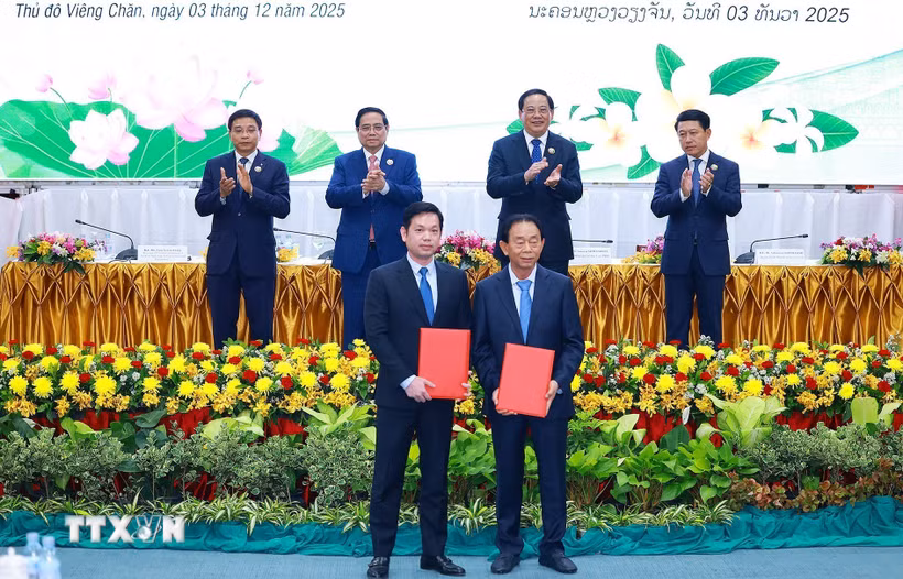 Thủ tướng Phạm Minh Chính và Thủ tướng Lào Sonexay Siphandone chứng kiến trao biên bản hợp tác giữa doanh nghiệp hai nước. (Ảnh: Dương Giang/TTXVN)