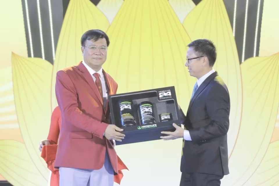 Đại diện các nhà tài trợ trao tượng trưng tài trợ cho Đoàn thể thao Việt Nam. (Ảnh: Minh Quyết/TTXVN)