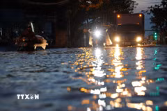 Đường Nguyễn Bình đoạn từ ngã tư Lê Văn Lương ngập sâu biến thành sông do triều cường dâng cao chiều 27/10. (Ảnh: Hồng Đạt/TTXVN)