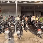 Nhóm thanh, thiếu niên tụ tập "đi bão" lúc rạng sáng cùng phương tiện được đưa về trụ sở Công an. (Ảnh: TTXVN phát)