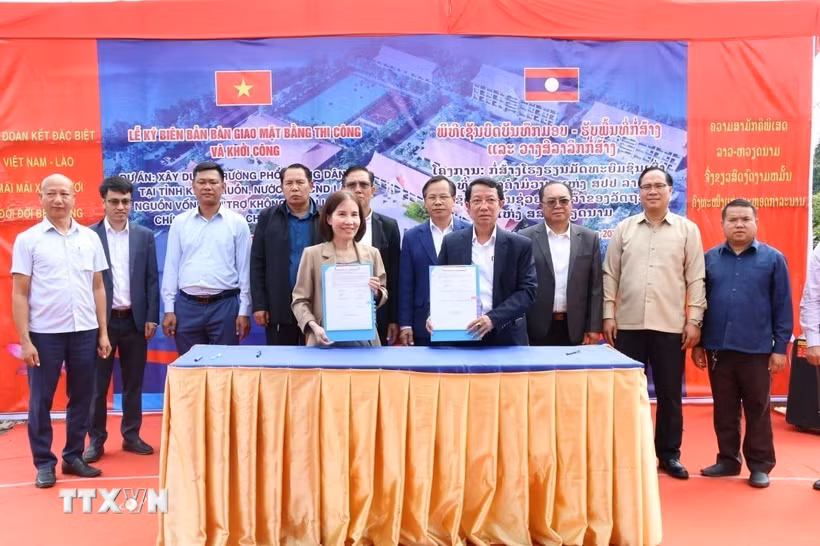 Lễ ký biên bản bàn giao mặt bằng thi công và khởi công dự án xây dựng Trường Phổ thông Dân tộc tỉnh Khammuon. (Ảnh: Xuân Tú/TTXVN)