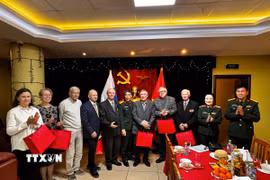 Đại tá, nhà văn Nguyễn Bỉnh Phương, Tổng biên tập Tạp chí Văn nghệ Quân đội, Phó chủ tịch Hội nhà văn Việt Nam (giữa) tặng quà tri ân các nhân chứng lịch sử. (Ảnh: Tâm Hằng/TTXVN)