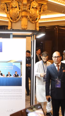 Tổng Giám đốc TTXVN Vũ Việt Trang, Người phát ngôn Điện Kremlin Dmitry Peskov, Tổng Giám đốc hãng thông tấn TASS Andrey Kondrashov và các đại biểu xem các bức ảnh tại triển lãm. (Ảnh: Văn Hiếu/TTXVN)